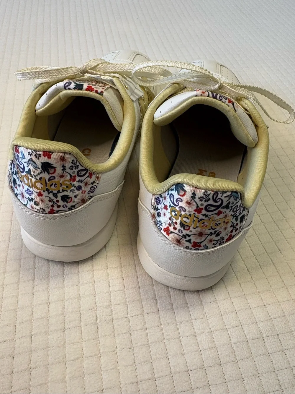 Adidas cream colored sneakers with floral accents